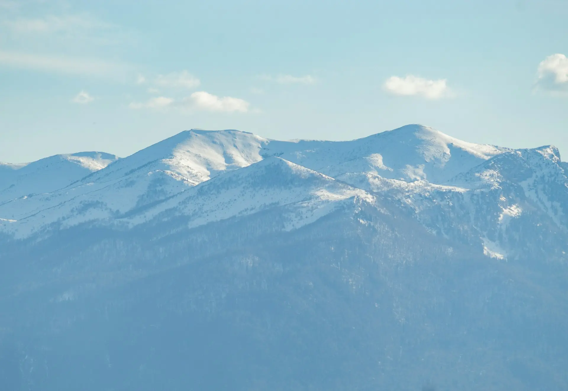 a snow covered mountain range in the distance